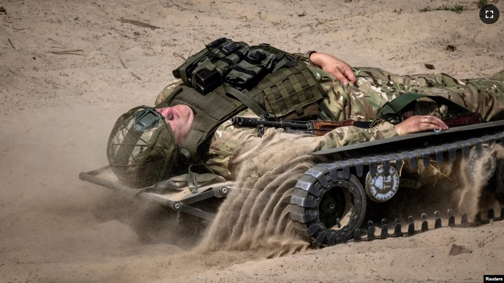 An ELECTROStretcher remote-controlled medical evacuation vehicle designed by Dmytro Mamonov carries a soldier during a presentation by various Ukrainian manufacturers at an undisclosed location outside Kyiv, Ukraine, May 28, 2024. (REUTERS/Thomas Peter)