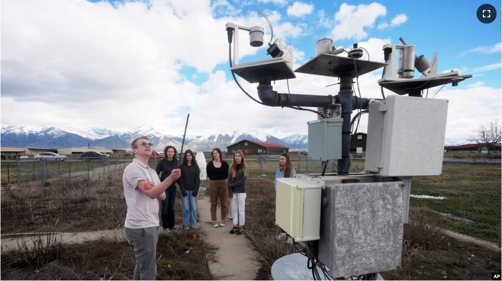Climate Data Analyst Casey Olson, left, of Utah State University, conducts a tour during a visit to the Utah Climate Center's climate reference station on April 1, 2024, in Logan, Utah. (AP Photo/Rick Bowmer)