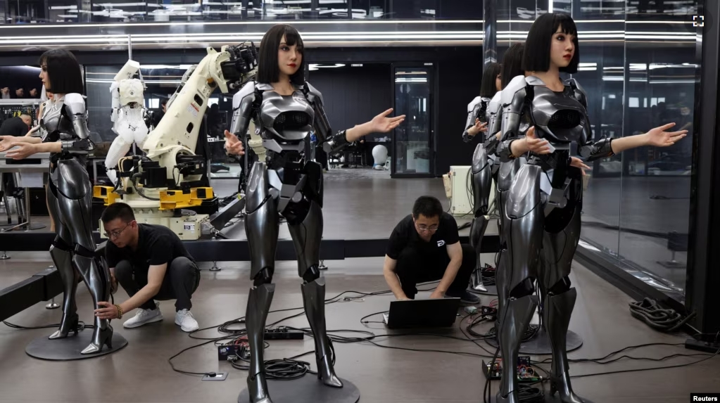 Employees work on humanoid robots at the office of developer Ex-Robots in Dalian, Liaoning province, China June 6, 2024. (REUTERS/Florence Lo)