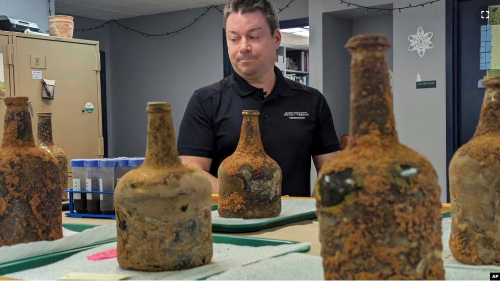 Jason Boroughs discusses artifacts found underneath George Washington's residence in Mount Vernon, Va., on June 17, 2024. Several 18th-century glass bottles containing fruit were unearthed in the mansion cellar of America's first president.(AP Photo/Nathan Ellgren)