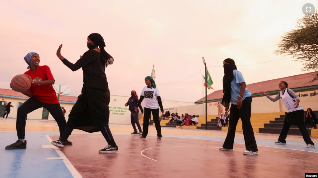 Sahra Omer, 17, member of the Hargeisa Basketball Girls team tussles to shoot a ball during their weekly training session in Hargeisa, Somaliland, May 20, 2024. (REUTERS/Tiksa Negeri)