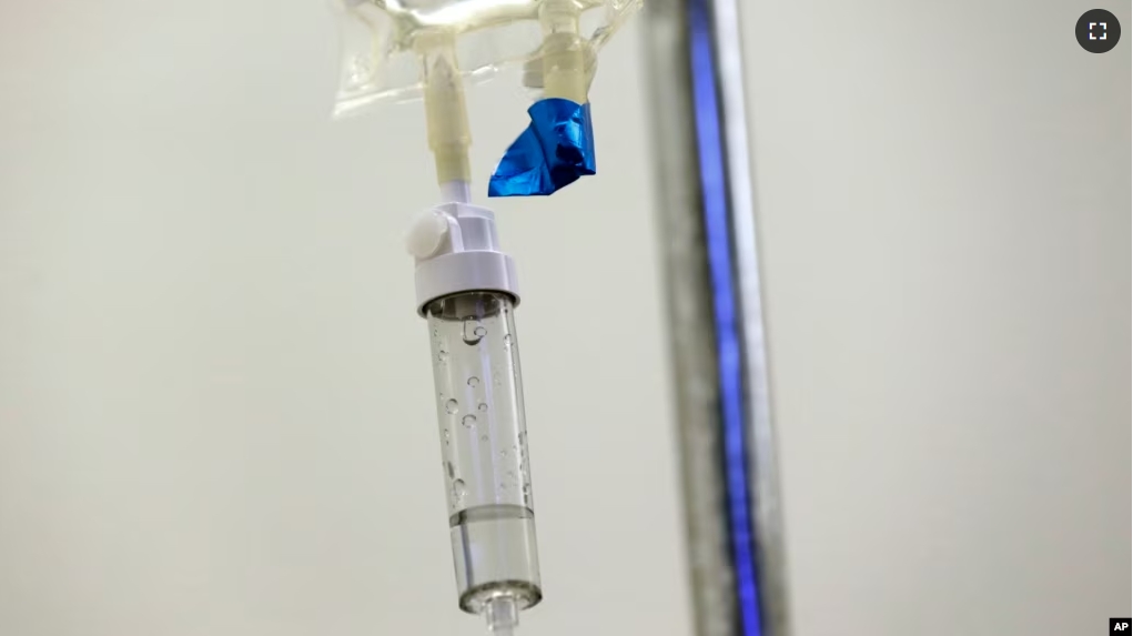 FILE - In this May 25, 2017 file photo, chemotherapy drugs are administered to a patient at a hospital in Chapel Hill, N.C. (AP Photo/Gerry Broome, File)