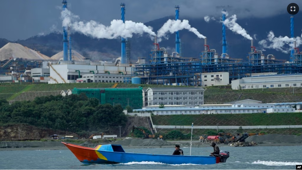 A boat cruises past the Indonesia Weda Bay Industrial Park in Central Halmahera, North Maluku province, Indonesia, Saturday, June 8, 2024. Indonesia has been building out a vast industry for nickel. (AP Photo/Achmad Ibrahim)