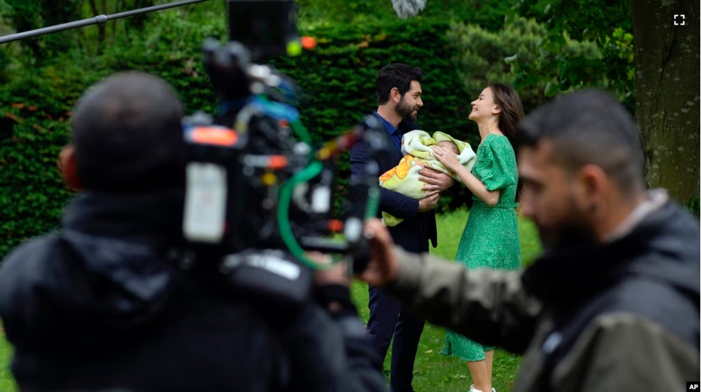 A production team is filming scenes of a Turkish drama with actor Paris Baktas and actress Yagmur Yuksel, Turkey, Tuesday, April 30, 2024. (AP Photo/Khalil Hamra)