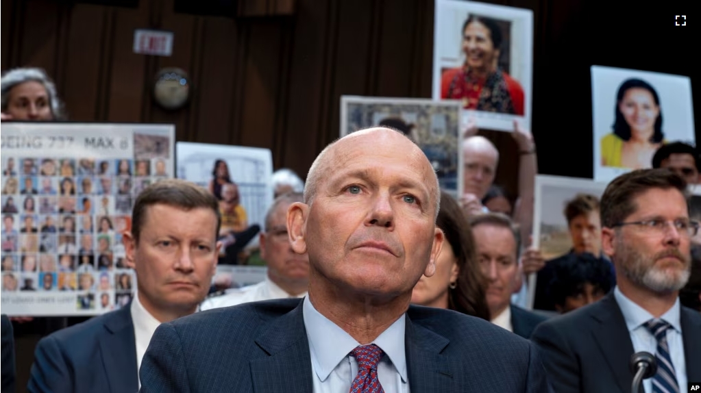 FILE - With protesters in the audience, Boeing CEO Dave Calhoun waits to testify before the Senate Homeland Security and Governmental Affairs Subcommittee on Investigations at the Capitol in Washington, Tuesday, June 18, 2024. (AP Photo/J. Scott Applewhite, File)