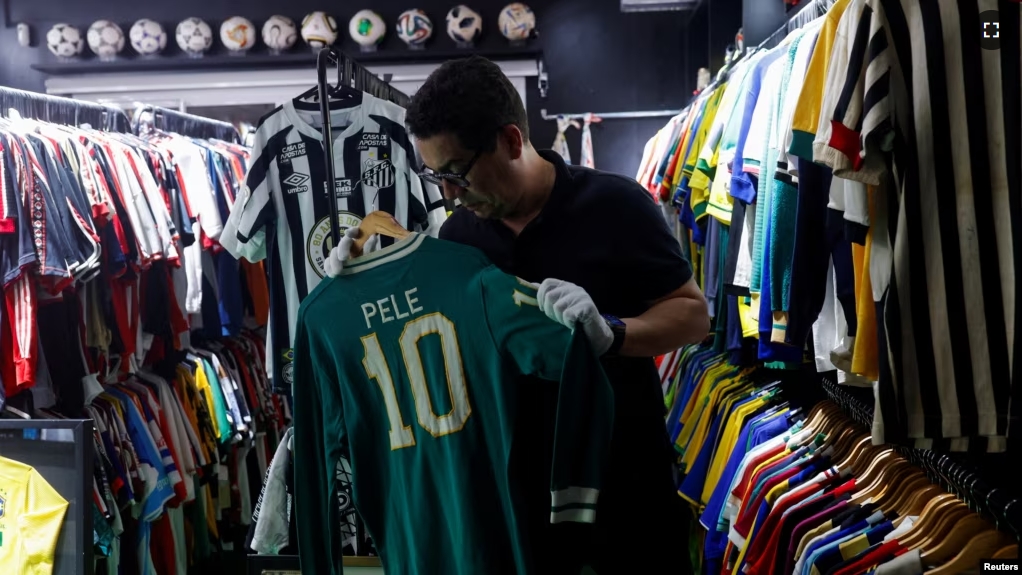 Cassio Brandao holds a shirt worn by Pele in a room filled with jerseys that made him a Guinness World Records holder of the world's largest collection of soccer shirts, in Sao Paulo, Brazil June 24, 2024. (REUTERS/Amanda Perobelli)