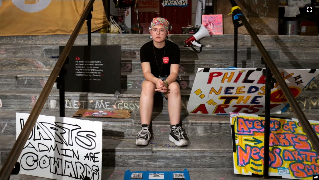 Cyrus Nasib, 18, sits on the steps of the University of the Arts, on June 14, 2024, in Philadelphia. Students at the university got the sudden news that their school would be shutting down within days. (AP Photo/Joe Lamberti)