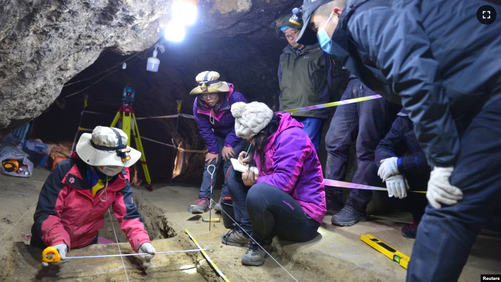 Scientists work inside Baishiya Karst Cave, where the remains of the extinct archaic human species called Denisovans have been discovered, on the northeastern edge of the Tibetan Plateau in China's Gansu province. Dongju Zhang's group (Lanzhou University/Handout via REUTERS)