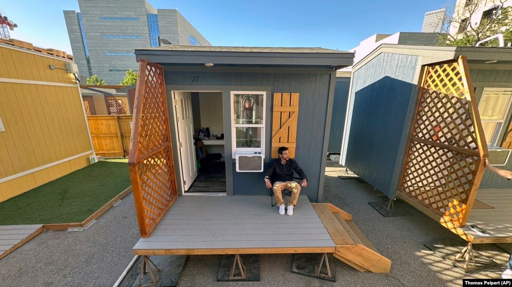 Eric Martinez sits outside of his room at a micro community in Denver on Wednesday, June 5, 2024. (AP Photo/Thomas Peipert)