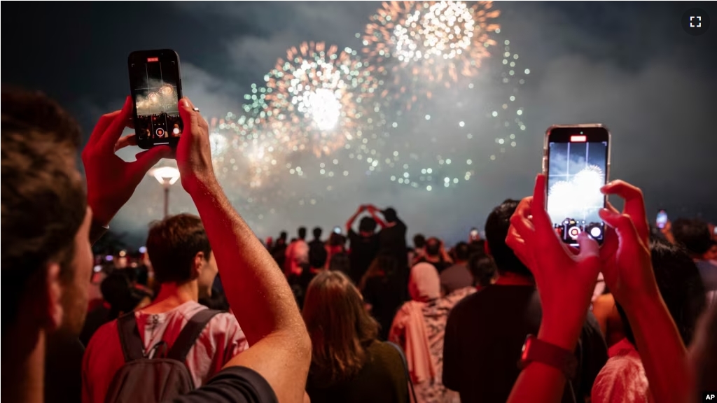 FILE - People watch the Macy's Fourth of July fireworks in New York, Tuesday, July 4, 2023. (AP Photo/Yuki Iwamura)