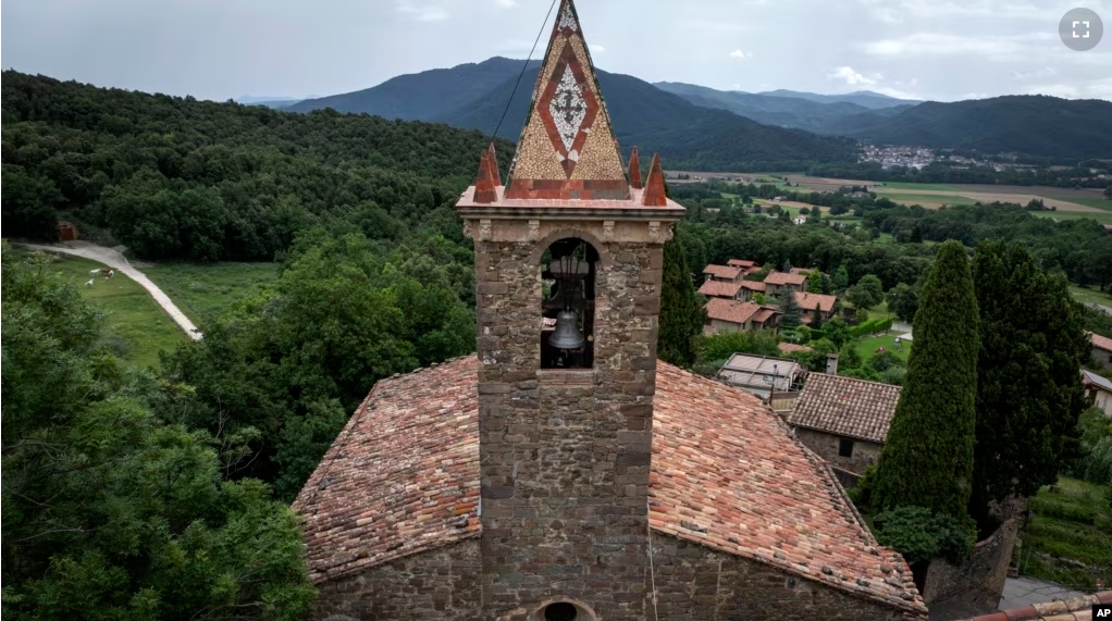 View of the bell tower of the 12th-century Sant Romà church, where students of the Vall d'en Bas School of Bell Ringers perform playing bells, in the small Spanish village of Joanetes, Spain, June 29, 2024. (AP Photo/Emilio Morenatti)