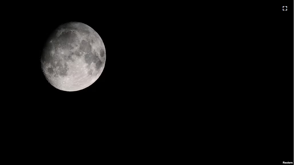 A view of the moon over a mountain in Garmisch-Partenkirchen, Germany, July 19, 2024. (REUTERS/Angelika Warmuth)