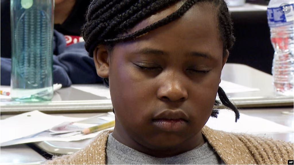 Aniyah Woods meditates in her classroom at Roberta T. Smith Elementary School, May 14, 2024, in Rex, Georgia. Schools across the U.S. have been introducing yoga, meditation and mindfulness exercises to help students manage stress and emotions. (AP Photo/Sharon Johnson)