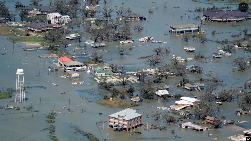 FILE - Buildings and homes are flooded in the aftermath of Hurricane Laura near Lake Charles, La., on Aug. 27, 2020. (AP Photo/David J. Phillip, File)