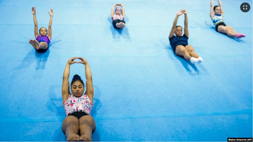 FILE - Panamanian gymnast Hillary Heron stretches as she trains for the Olympics at the No Limits Gymnastics Center in Panama City, Saturday, June 15, 2024, ahead of the Games in Paris. (AP Photo/Matias Delacroix, File)