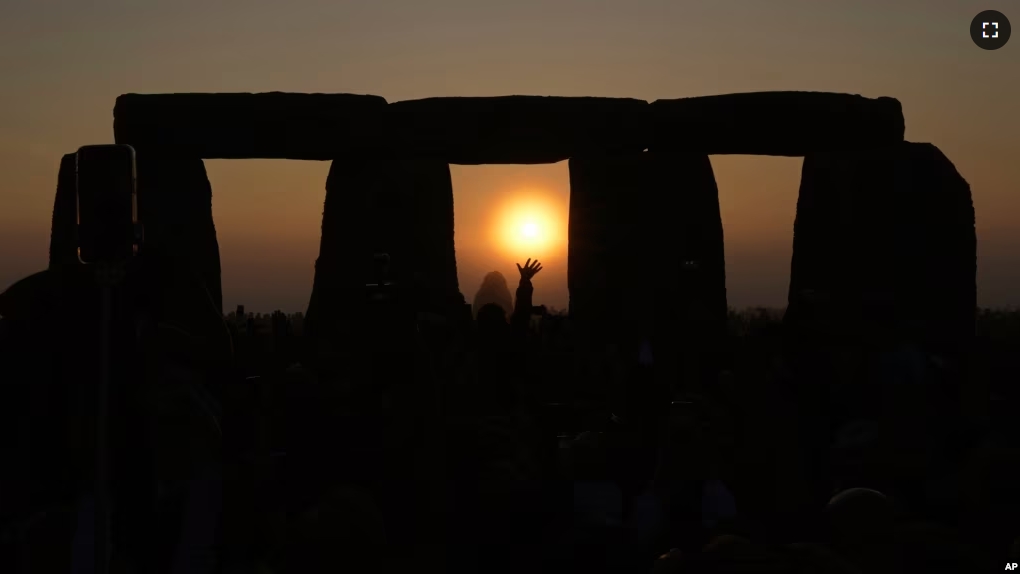 FILE - Revelers gather at the ancient stone circle Stonehenge to celebrate the Summer Solstice, the longest day of the year, near Salisbury, England, Wednesday, June 21, 2023. (AP Photo/Kin Cheung, File)