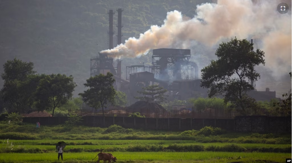 FILE - Smoke rises from a coal-powered steel plant at Hehal village near Ranchi, in the eastern state of Jharkhand, Sept. 26, 2021. (AP Photo/Altaf Qadri, File)