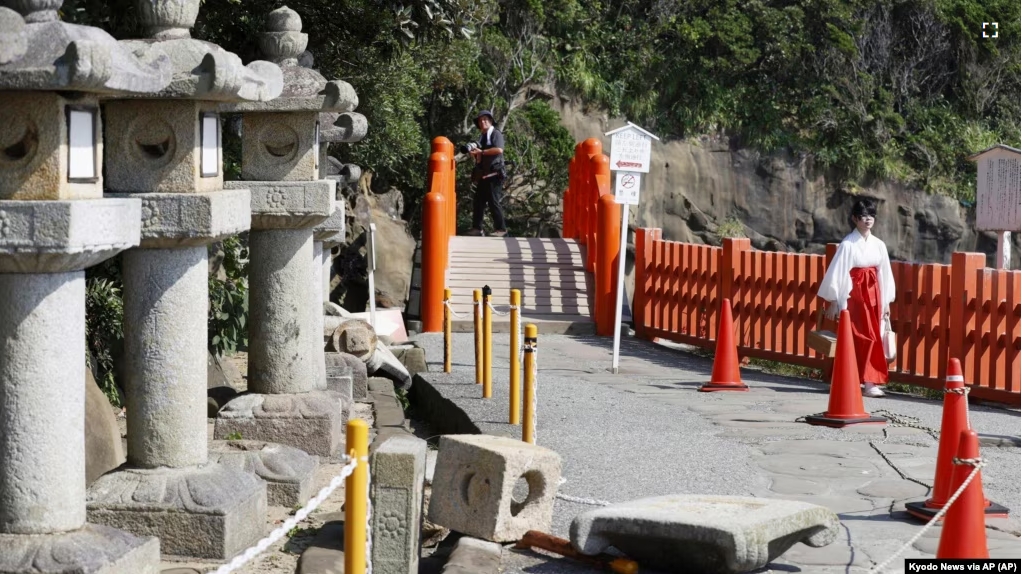 Stone lanterns fall at a shrine following a strong earthquake in Nichinan, Miyazaki prefecture, southern Japan, on Aug. 9, 2024. (Kyodo News via AP)