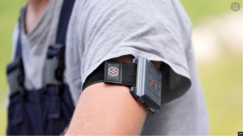 A SlateSafety armband is worn by Wyatt Fischer, a furnace mason employee at Cardinal Glass, Thursday, Aug. 22, 2024, in Menomonie, Wis. (AP Photo/Abbie Parr)