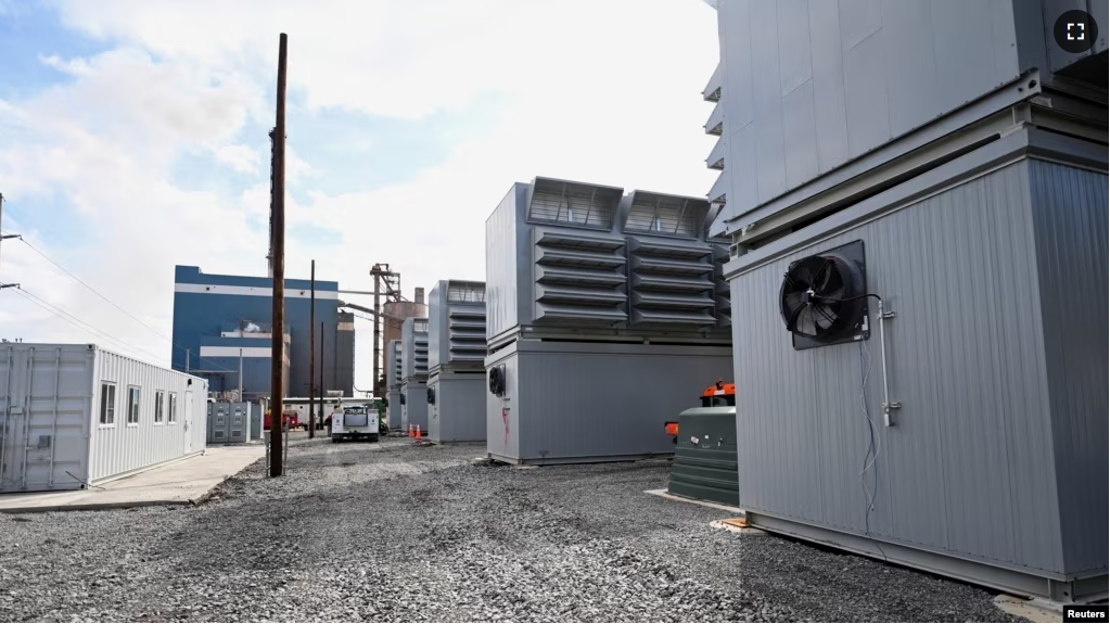 FILE - A group of buildings housing cryptocurrency miners sits in the foreground of a power generating station at the Scrubgrass Plant in Kennerdell, Pennsylvania, U.S., March 8, 2022. Picture taken March 8, 2022. (REUTERS/Alan Freed)