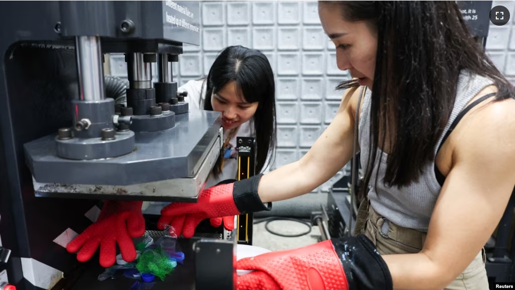 Debbie Wu operates miniTrashpresso, which turns plastic waste into materials to make sunglasses, at Trash Kitchen in Taipei, Taiwan August 19, 2024. (REUTERS/Ann Wang)