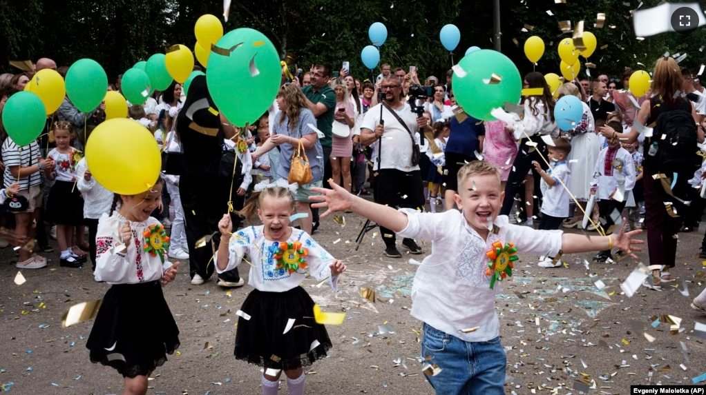 First-graders attend the traditional ceremony for the first day of school in Zaporizhzhia, Ukraine, Sunday Sept. 1, 2024. (AP Photo/Evgeniy Maloletka)