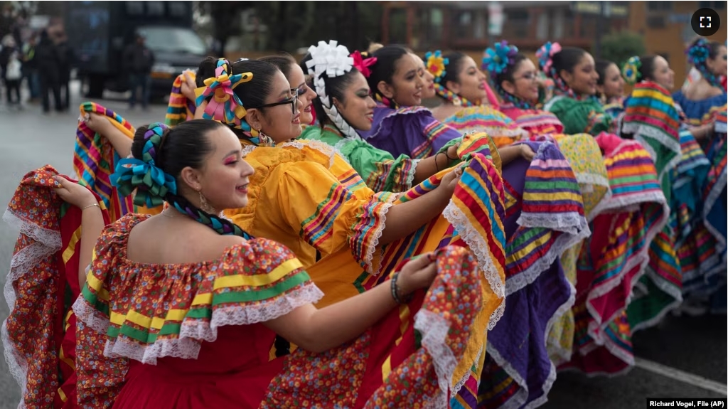 FILE - Members of the Cathedral City High School Ballet Folklorico pose for photo prior to joining in the Kingdom Day Parade in Los Angeles, Jan. 16, 2023.