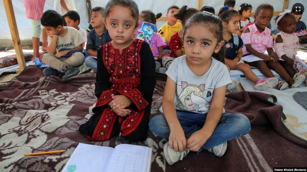 Palestinian students attend a class in a tent in Khan Younis, in the southern Gaza Strip, September 4, 2024. (REUTERS/Hatem Khaled)