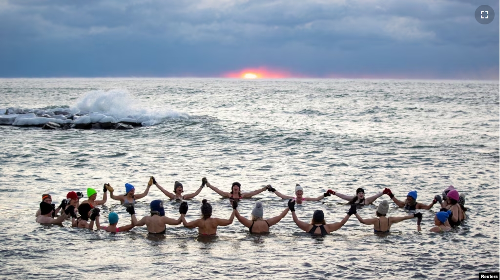 FILE - A group consisting mostly of women, who call themselves "The Endorphins", gather for a sunrise swim in the chilly waters of Lake Ontario during freezing temperatures in Toronto, Ontario, Canada, Jan. 17, 2024. (REUTERS/Carlos Osorio)