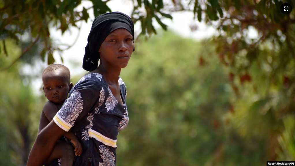 Twenty-eight-year-old Milla Nemoudji, a woman who was divorced by her husband following years of physical abuse, is photographed in a village of Binmar, Chad, Friday, July 19, 2024. (AP Photo/Robert Bociaga)