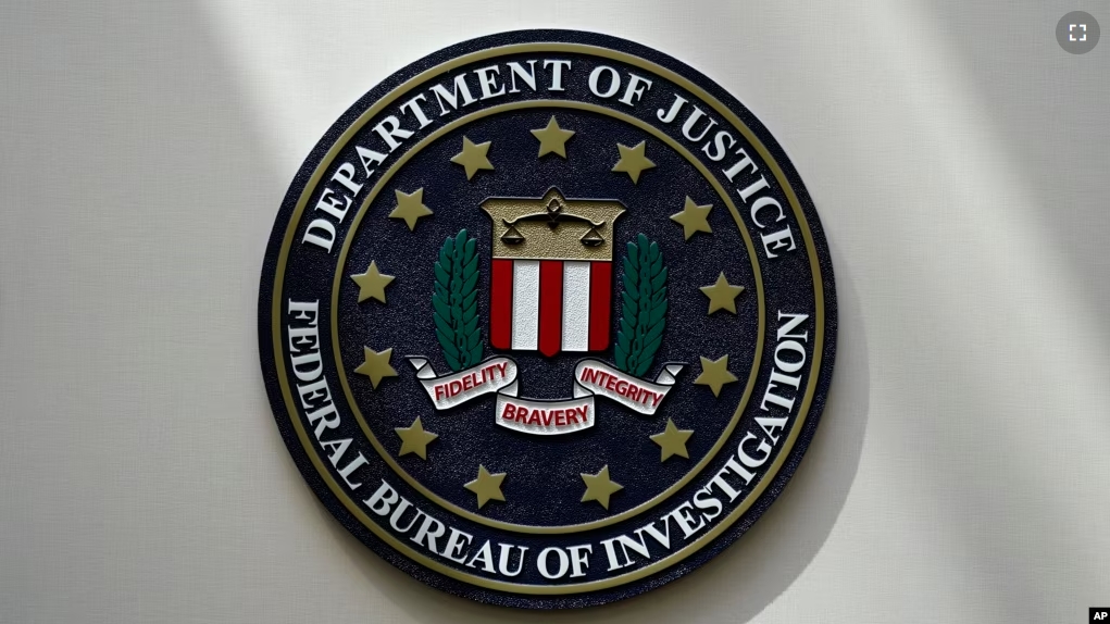 FILE - An FBI seal is seen on a wall on Aug. 10, 2022, in Omaha, Neb. Violent crime in the US dropped again in 2023, according to FBI statistics. (AP Photo/Charlie Neibergall, File)