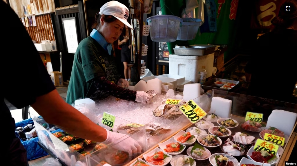 Vendors prepare seafood for sale at Tsukiji Outer Market in Tokyo, Japan, August 12, 2024. (REUTERS/Willy Kurniawan)