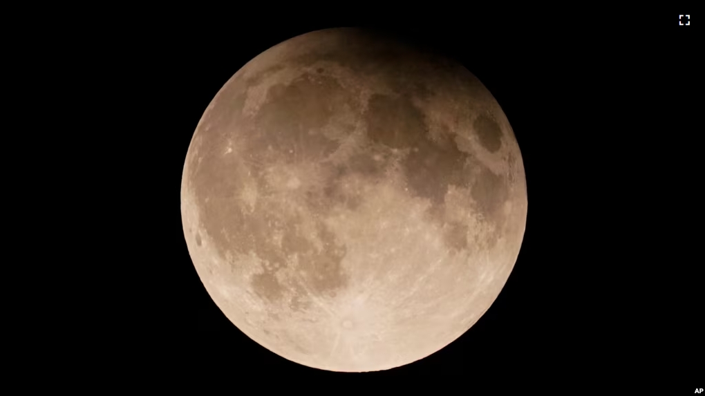 This file image shows a supermoon with a partial lunar eclipse rises over Lake Michigan in Chicago, Tuesday, Sept. 17, 2024. (AP Photo/Kiichiro Sato, File)