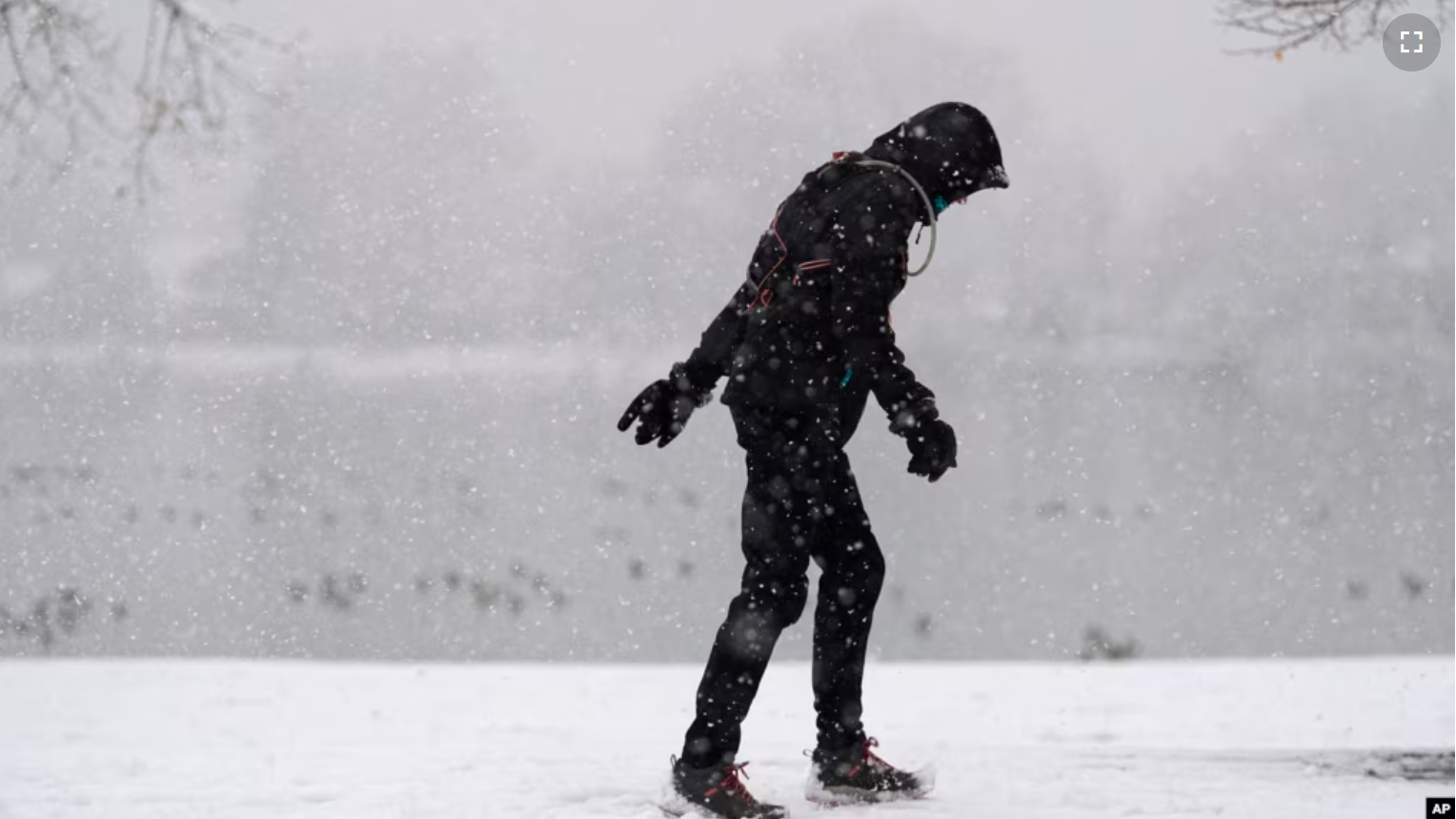 FILE - A lone walker moves around Washington Park as a winter storm packing wet, heavy snow moves through the area on Feb. 3, 2024, in Denver. (AP Photo/David Zalubowski)