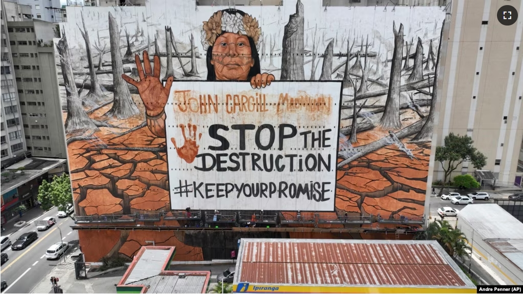 A mural by artist-activist Mundano depicting the drought in the Amazon rainforest using paint made from the ashes of wildfires in the Amazon and mud from the floods in southern Brazil covers a building in Sao Paulo, Tuesday, Oct. 22, 2024. (AP Photo/Andre Penner)