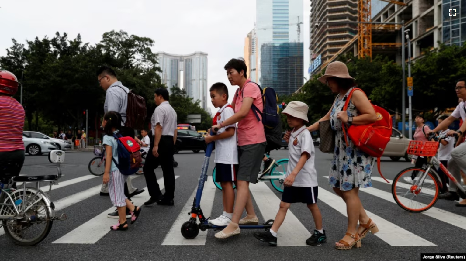 FILE - Children and their parents are seen on their way to the school in Tianhe district in Guanghzou, China, September 4, 2019. (REUTERS/Jorge Silva/File Photo)