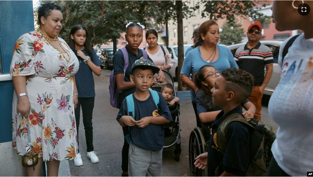 FILE - Damien Salinas, center front, arrives at school on Sept. 7, 2023, in New York. Damien attends his first day of school in New York City after his family emigrated from Ecuador in June. (AP Photo/Andres Kudacki)