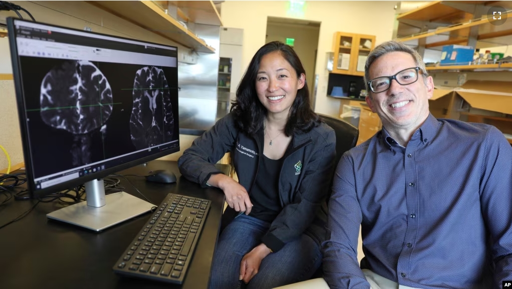 This undated photo provided by the Oregon Health & Science University in October 2024 shows Drs. Erin Yamamoto (L) and Juan Piantino, who used special imaging to spot a long-suspected pathway the human brain uses to clear waste. (Christine Torres Hicks/OHSU via AP)