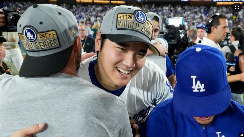 Los Angeles Dodgers' Shohei Ohtani celebrates after their win against the New York Mets in Game 6 of a baseball NL Championship Series, Sunday, Oct. 20, 2024, in Los Angeles. The Dodgers will face the New York Yankees in the World Series. (AP Photo/Ashley Landis)