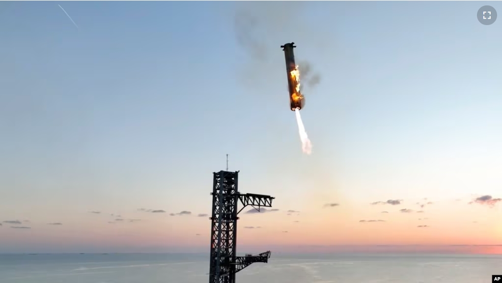 This image provided by SpaceX shows SpaceX's mega rocket booster returning to the launch pad to be captured during a test flight Sunday, Oct. 13, 2024, in Boca Chica, Texas. (SpaceX via AP)