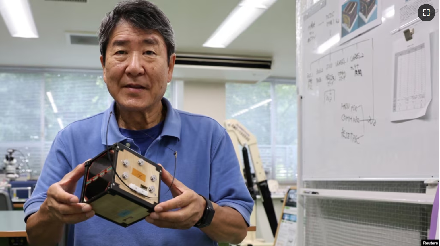 Takao Doi, a former Japanese astronaut and professor at Kyoto University, holds an engineering model of LignoSat during an interview with Reuters at his laboratory at Kyoto University in Kyoto, Japan, October 25, 2024. (REUTERS/Irene Wang)