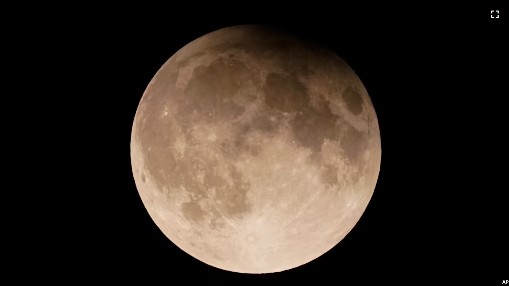 FILE - A supermoon with a partial lunar eclipse rises over Lake Michigan in Chicago, Sept. 17, 2024. (AP Photo/Kiichiro Sato, File)