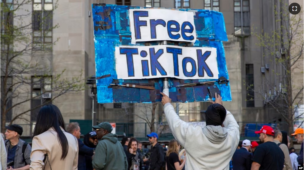 In this file photo, a man carries a Free TikTok sign in front of the courthouse where a trial of Donald Trump was underway on April 15, 2024, in New York. (AP Photo/Ted Shaffrey, File)