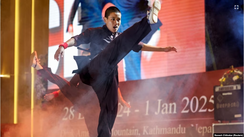 A Kung Fu nun demonstrates her skills during the reopening of the nun's center at Druk Amitabha Mountain Nunnery in Kathmandu, Nepal Dec. 30, 2024.