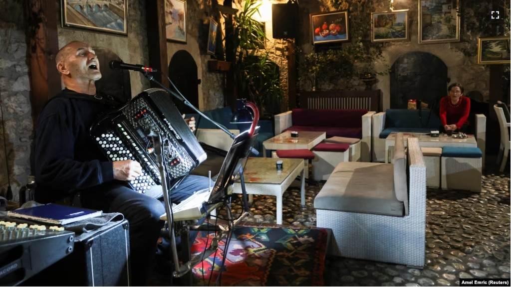 Bosnian musician Enes Salman plays the accordion while performing the traditional love song Sevdalinka, in Sarajevo, Bosnia and Herzegovina, December 20, 2024. (REUTERS/Amel Emric)