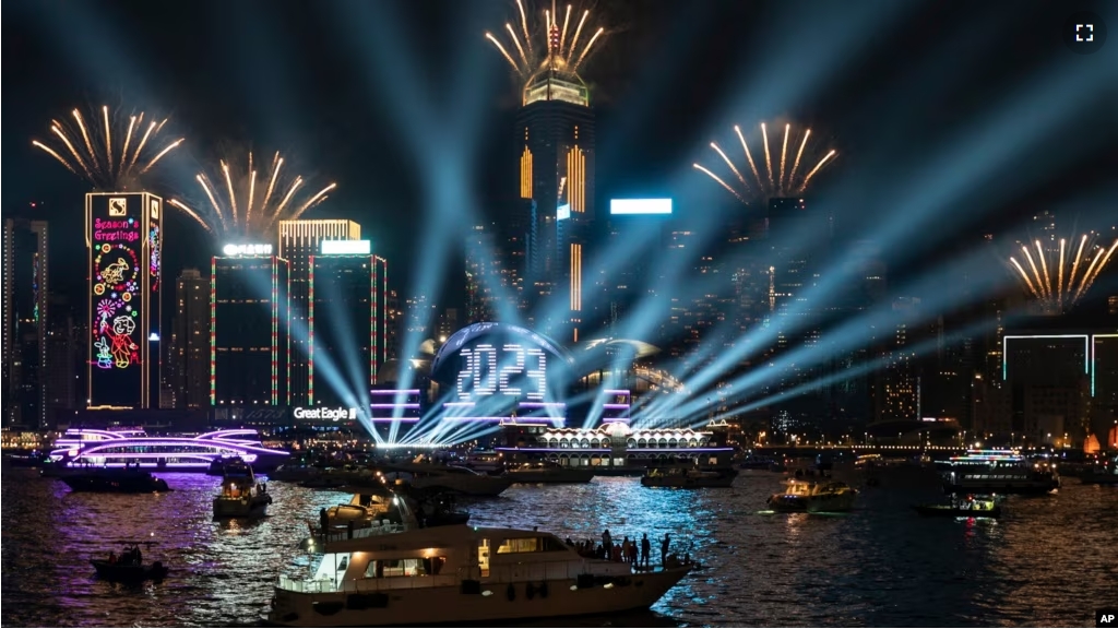 FILE - Fireworks are seen over Victoria Harbour at midnight on New Years Sunday Jan. 1, 2023 in Hong Kong. (AP Photo/Anthony Kwan)