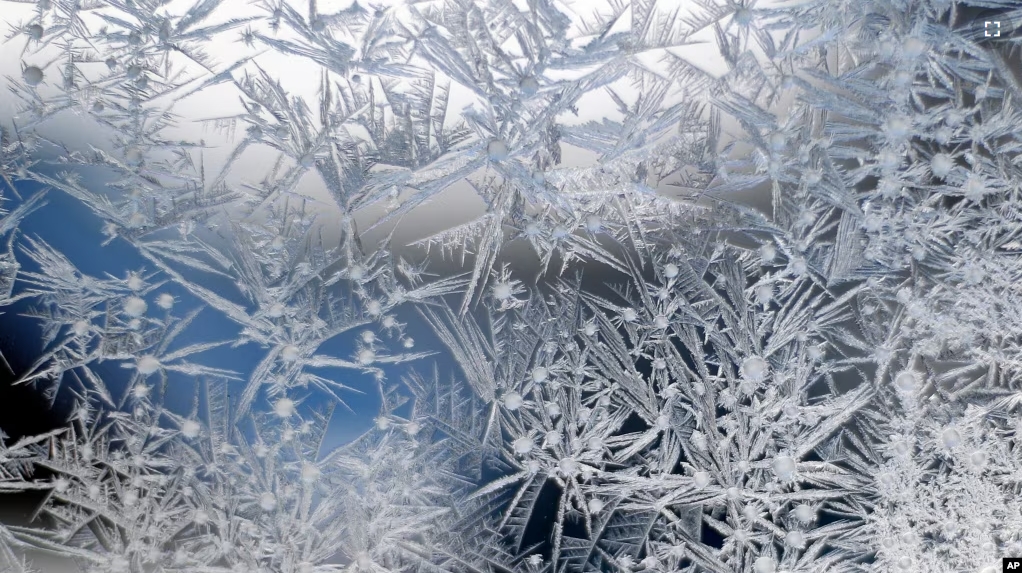 Ice crystals cover glass in Detroit, Monday, Jan. 21, 2019. Falling temperatures replaced the weekend's falling snow Monday as bitter cold and gusty winds swept across the eastern United States. (AP Photo/Paul Sancya)