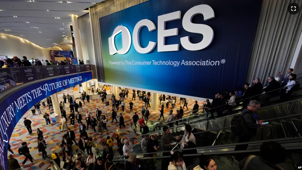 People attend the CES tech show Wednesday, Jan. 8, 2025, in Las Vegas. (AP Photo/John Locher)