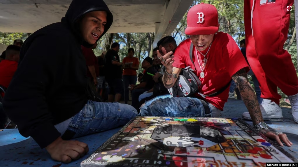 People play poleana, a board game invented in prison, before a tournament in Mexico City, Sunday, Nov. 17, 2024. (AP Photo/Ginnette Riquelme)