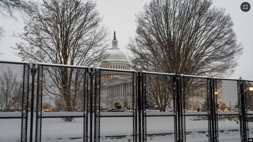 Security fencing surrounds Capitol Hill as snow blankets the region ahead of a joint session of Congress to certify the votes from the Electoral College in the presidential election, in Washington, Monday, Jan. 6, 2025. (AP Photo/J. Scott Applewhite)